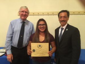 Mt. Whitney High School grad Gabriela “Gaby” Santillan is presented with the Every Student Succeeding Award by David Tonini (left) and Ralph Porras.
