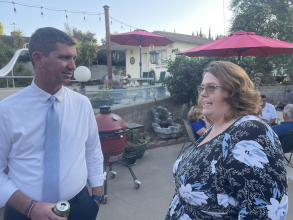 man and women in dressy clothes at an outdoor party